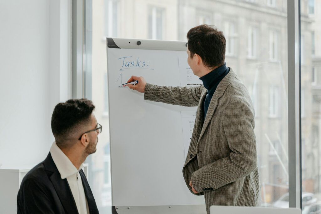 A senior leader coaching a younger professional during a strategy discussion